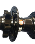 A close-up of a black bicycle hub component with a rear sprocket and front cogs.