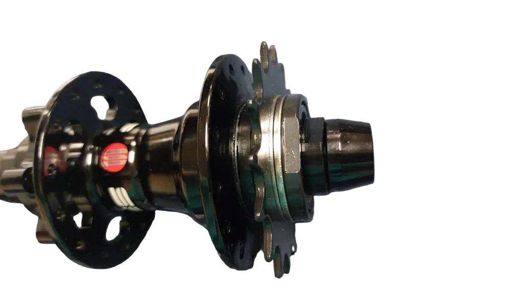 A close-up of a bicycle hub component with black and dark metallic parts.