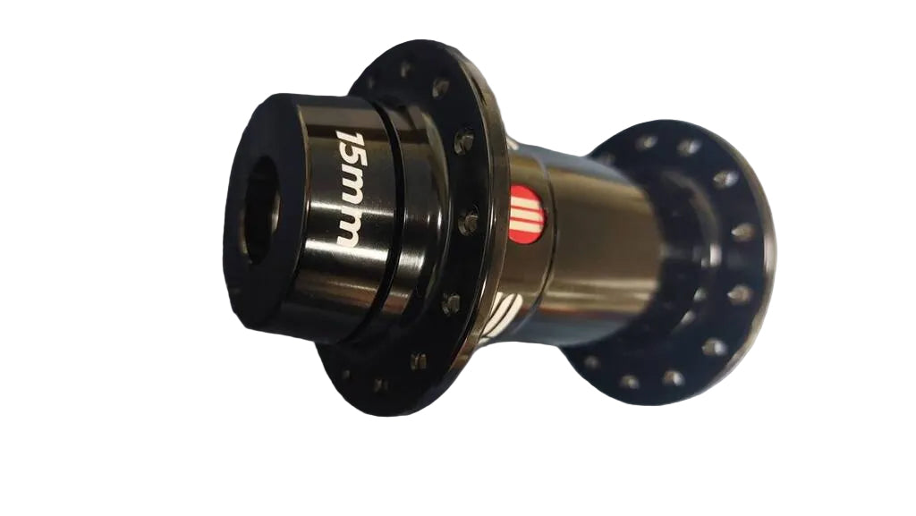 A close-up of a bicycle hub component with a black flange, a  center section marked '15mm', and a small red accent ring.