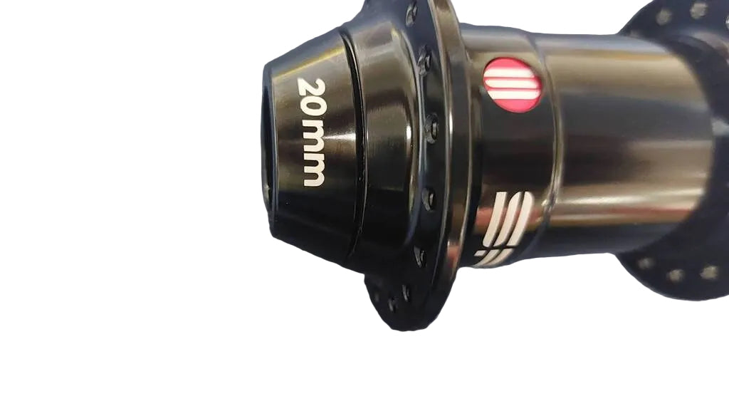 A close-up of a black bicycle hub with '20mm' printed in white on the cone.