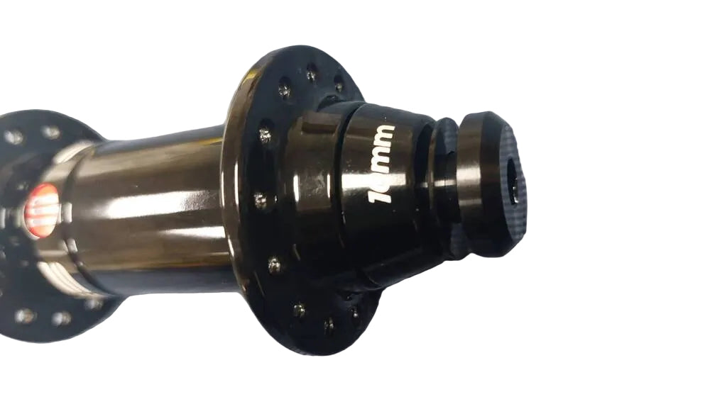 A close-up of a black bicycle hub with '10mm' printed in white on its side.