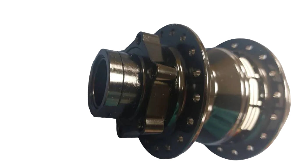 A close-up of a bicycle hub component with a black outer flange and metallic silver and bronze-toned inner parts..