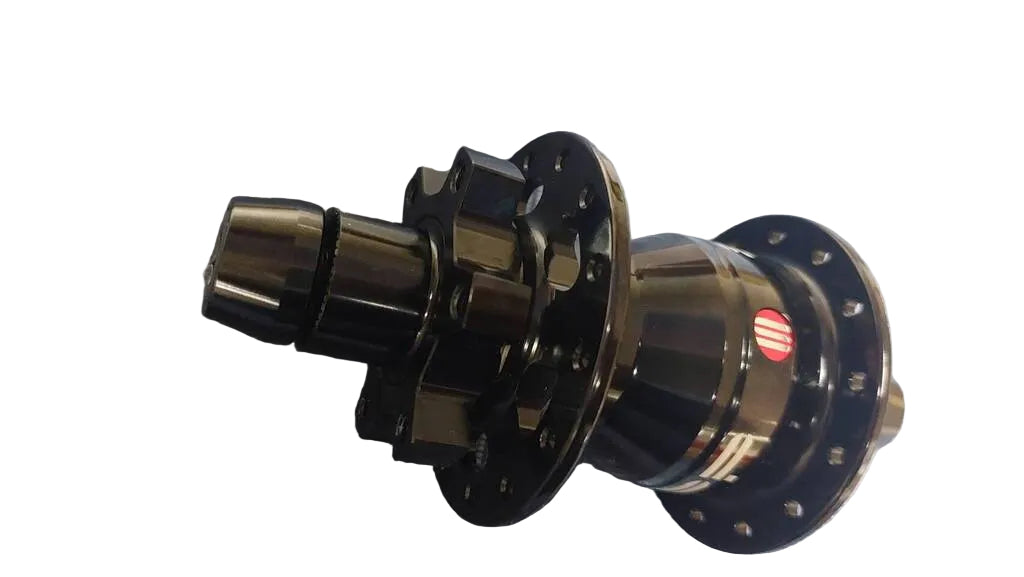 A black bicycle hub with a metallic finish, featuring a small red and white stripe on its side.