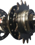 A close-up of a bicycle hub component with a black multi-spoke wheel disc.